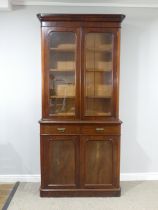 A Victorian mahogany glazed Bookcase, moulded cornice over glazed doors and three adjustable