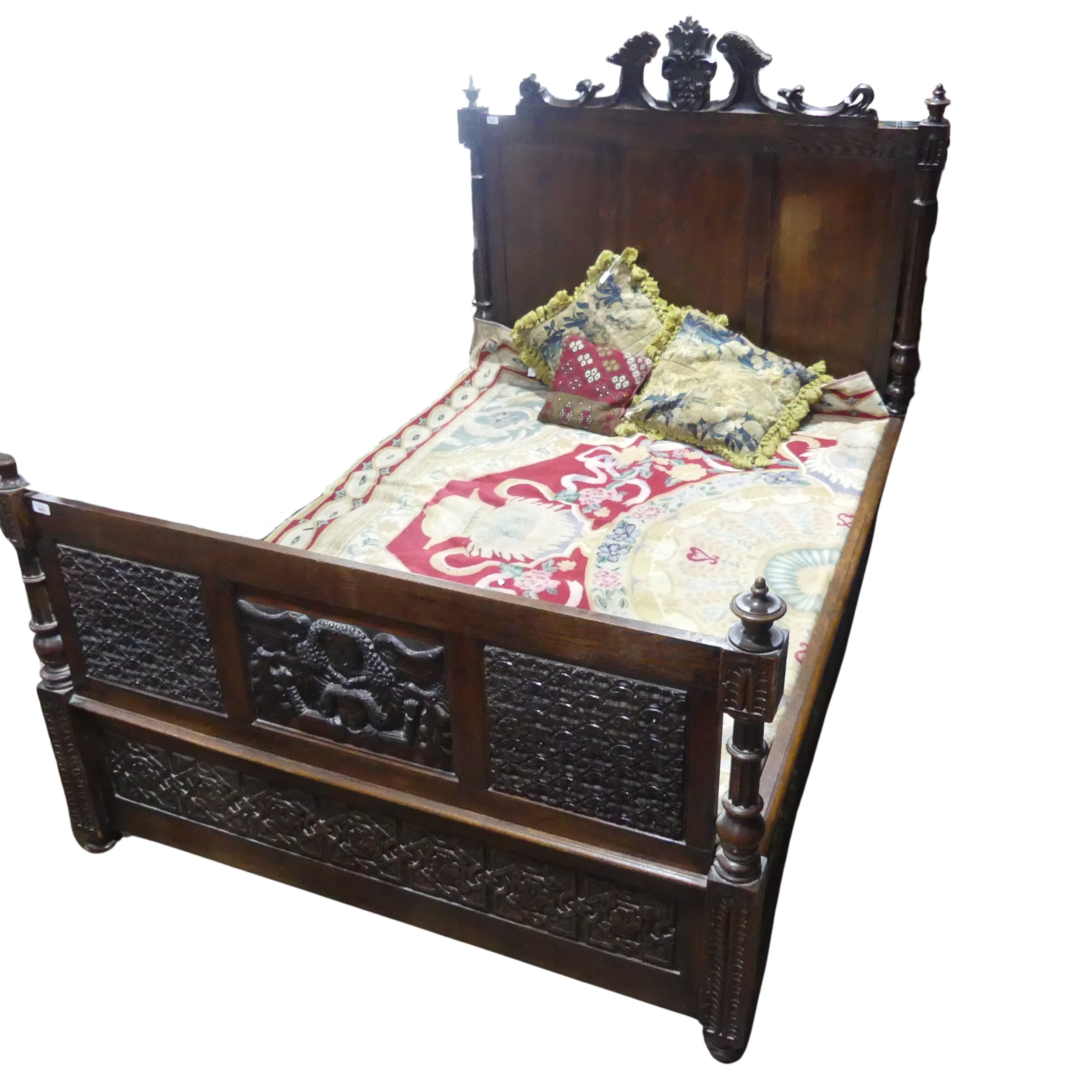 An antique carved oak framed double Bed, formed of 17th century and later oak carved panels, with