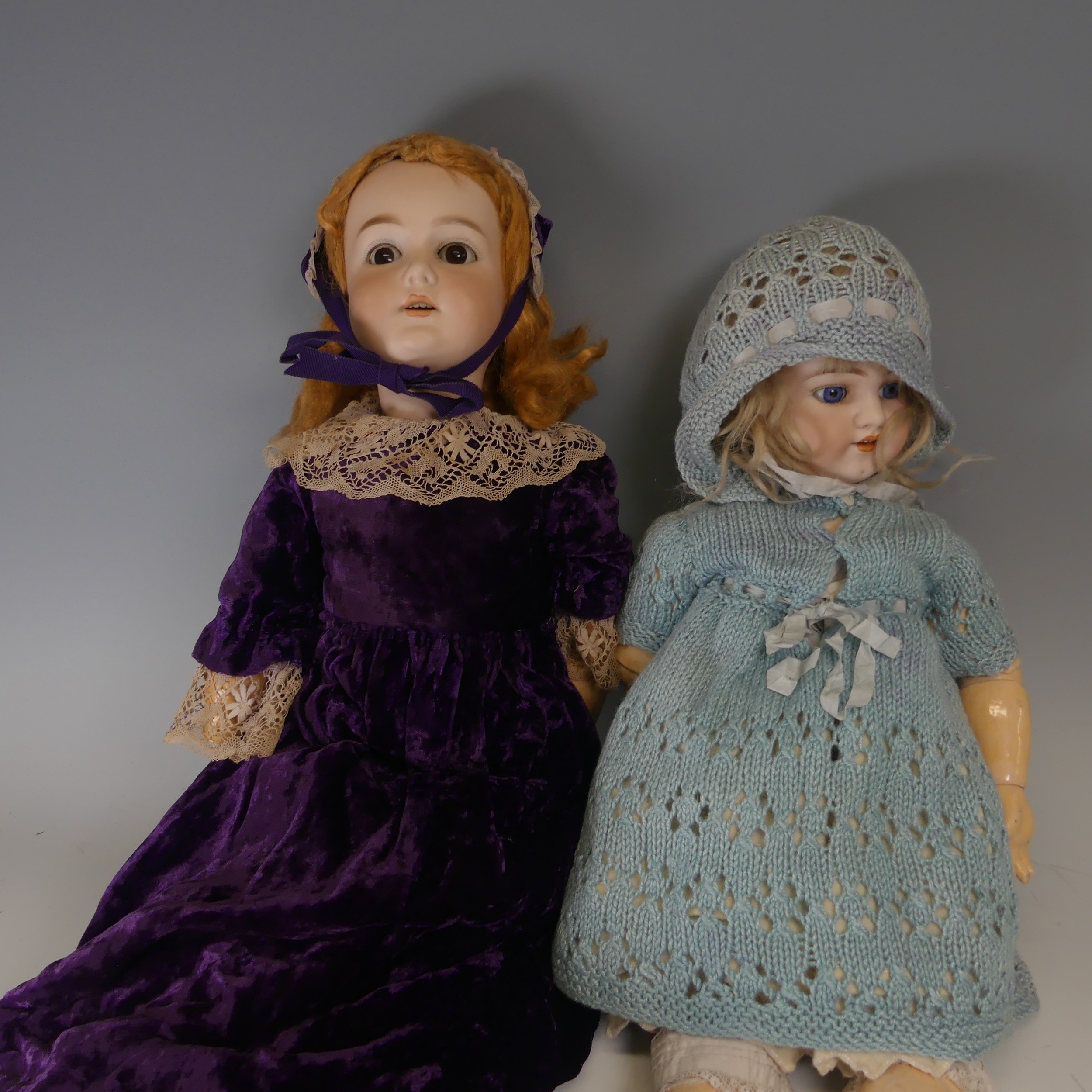 A Schoenau & Hoffmeister bisque head Doll, blue glass sleeping eyes, open mouth with four upper