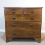 An Edwardian mahogany Chest of drawers, two short drawers over three long graduating drawers, raised