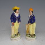 A pair of late 19thC Staffordshire Pottery figures of Cricketers, in blue jackets and yellow