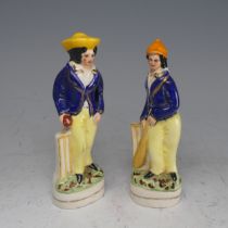 A pair of late 19thC Staffordshire Pottery figures of Cricketers, in blue jackets and yellow