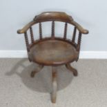 A late 19th century ash and elm Smokers elbow swivel desk Chair, turned column back rests, over