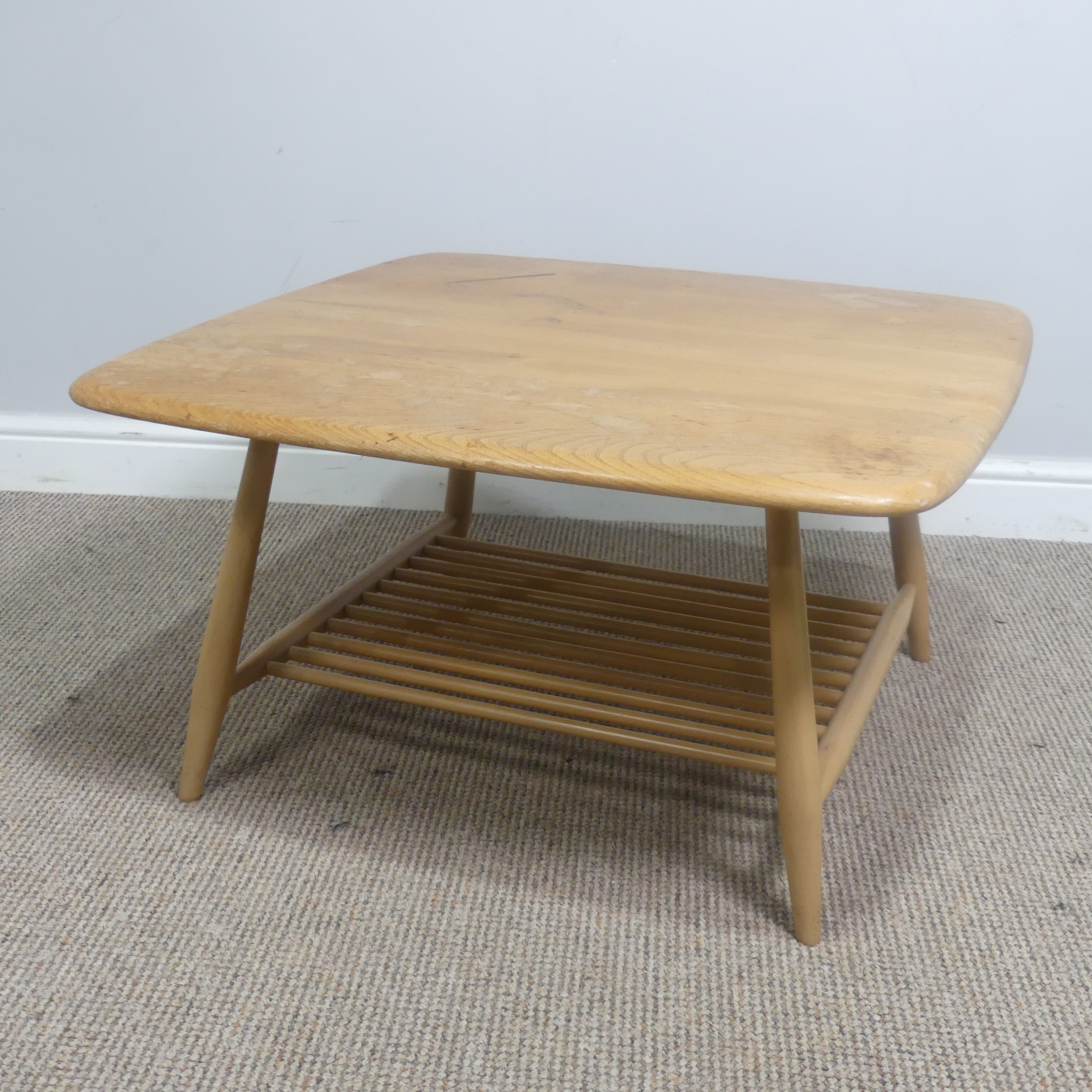 An Ercol windsor model 767 elm square coffee Table, with square top over splayed beach supports