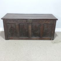 A 17th century and later oak Coffer, rectangular plank top over 17th century carved panels, raised