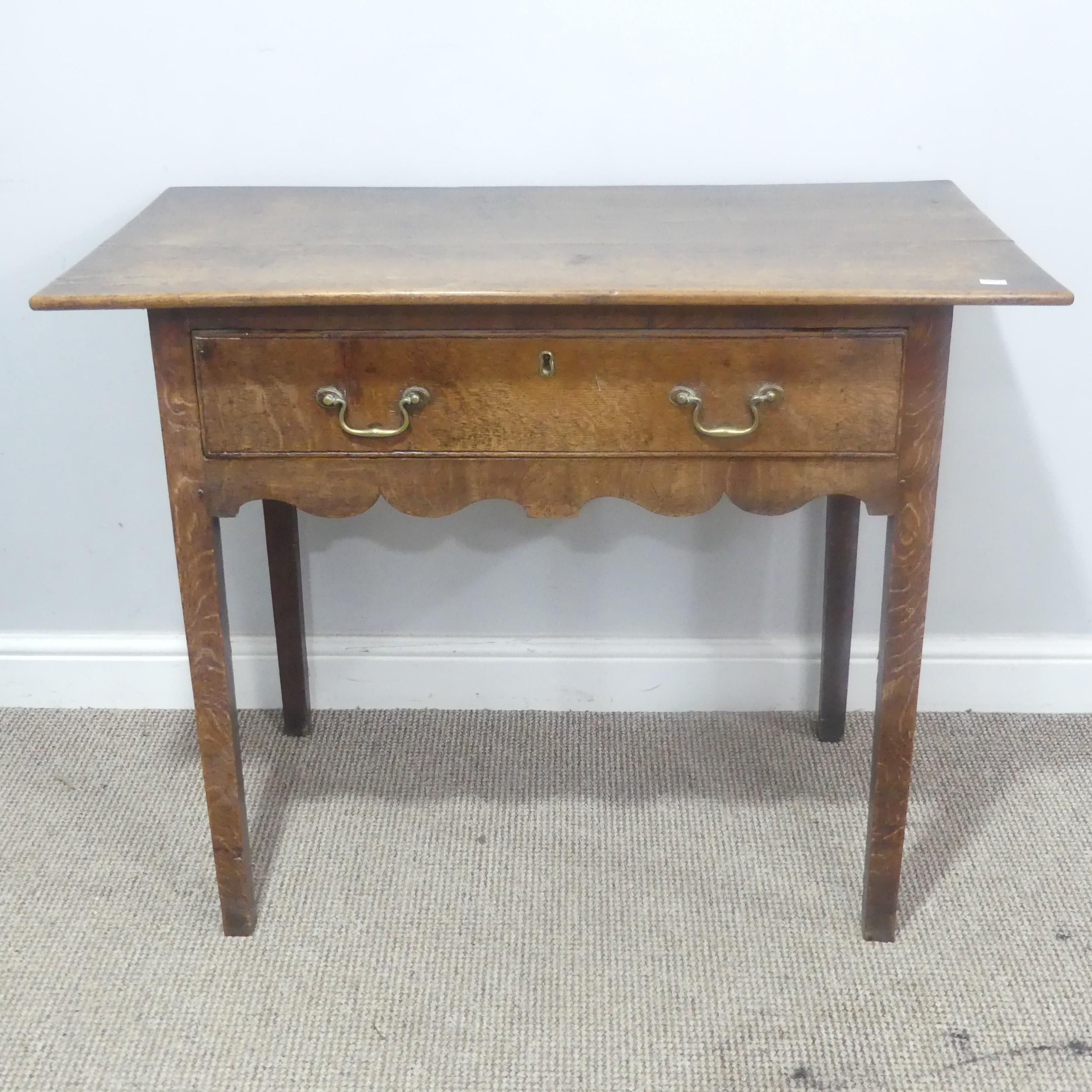 A Georgian oak side Table, overhanging rectangular top over single drawer and moulded frieze, raised