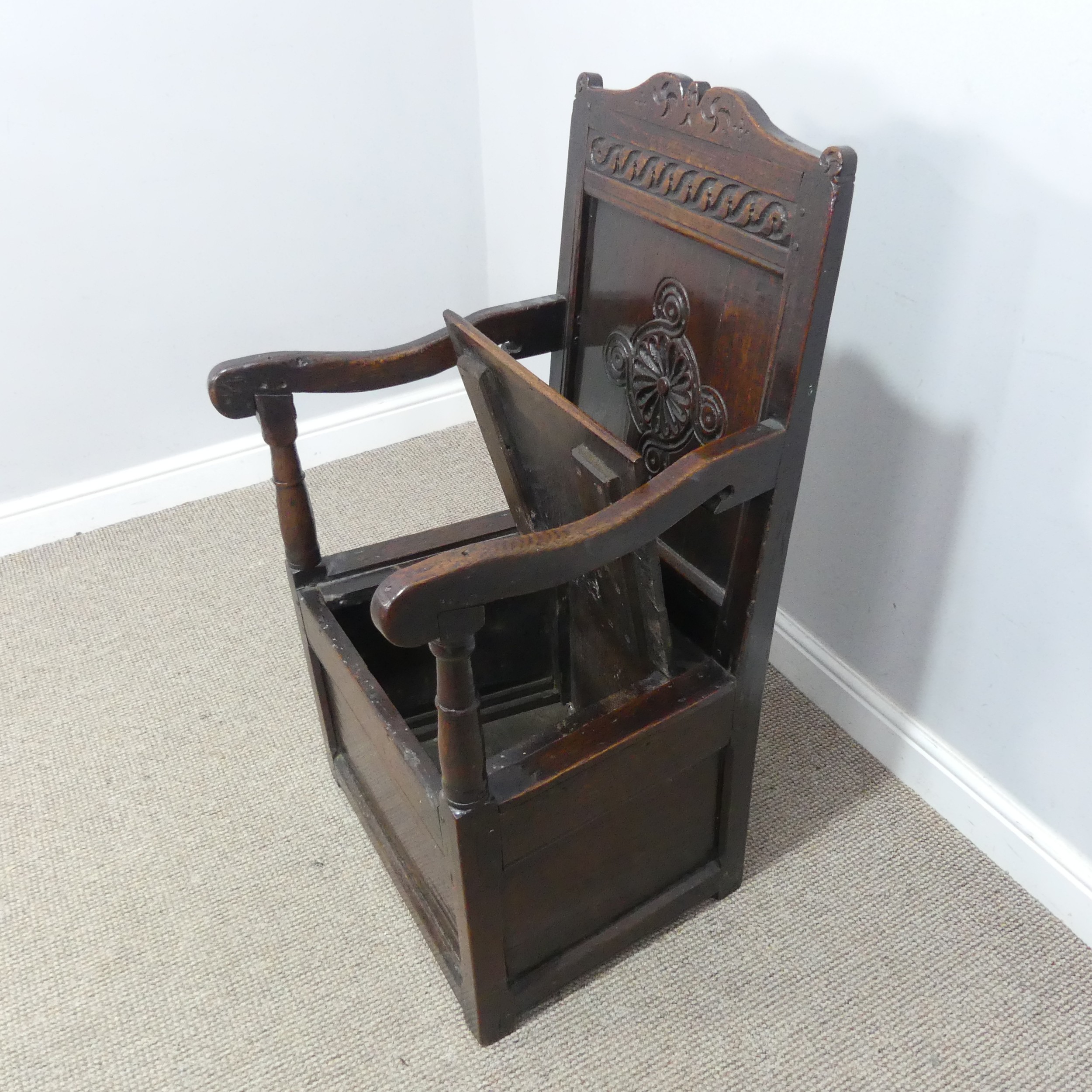 An antique probably 17th century oak wainscot box seat Armchair, carved backrest flanked by scrolled - Image 5 of 11