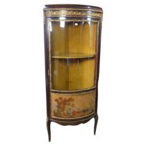 A French Louis XVI style bow-fronted corner display Cabinet, with gilt metal mounts depicting floral