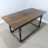 An 18th century oak farmhouse Table, four planked top with cleated ends, raised on turned legs and