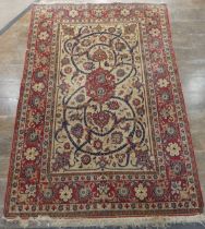 Tribal Rugs; a finely hand-knotted old Isfahan silk rug, of classic design, the cream ground woven