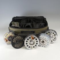 A collection of Fishing Reels in a Wilderness padded reel Bag, reels include a Pflueger Trion fly