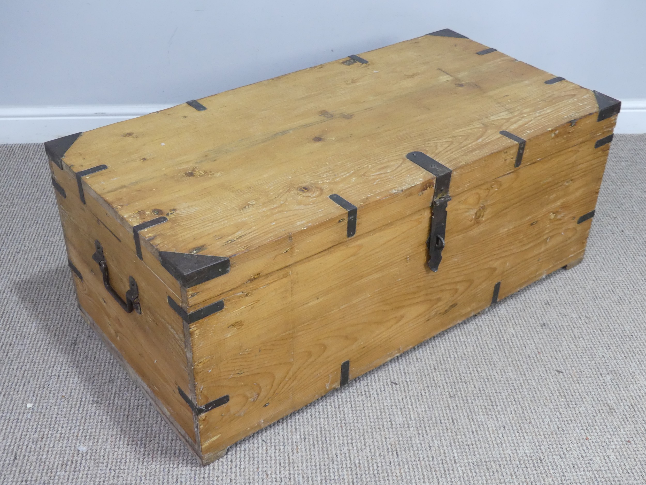A large antique pine and metal bound Trunk, metal lined, W 107 cm x H 43 cm x D 54 cm.