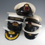 A collection of 7 Royal Navy 'summer' peaked Caps, including 'Army and Navy Hat and Cap Co Ltd', 'S.