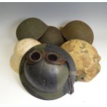 A group of six WW2 period and later military Helmets, including ;  A US 1970s helmet headband