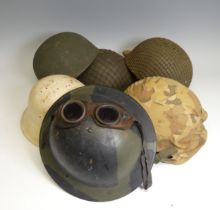 A group of six WW2 period and later military Helmets, including ;  A US 1970s helmet headband