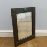 In the manner if Liberty, an Arts and Crafts copper wall Mirror, with central cabochon / roundle,