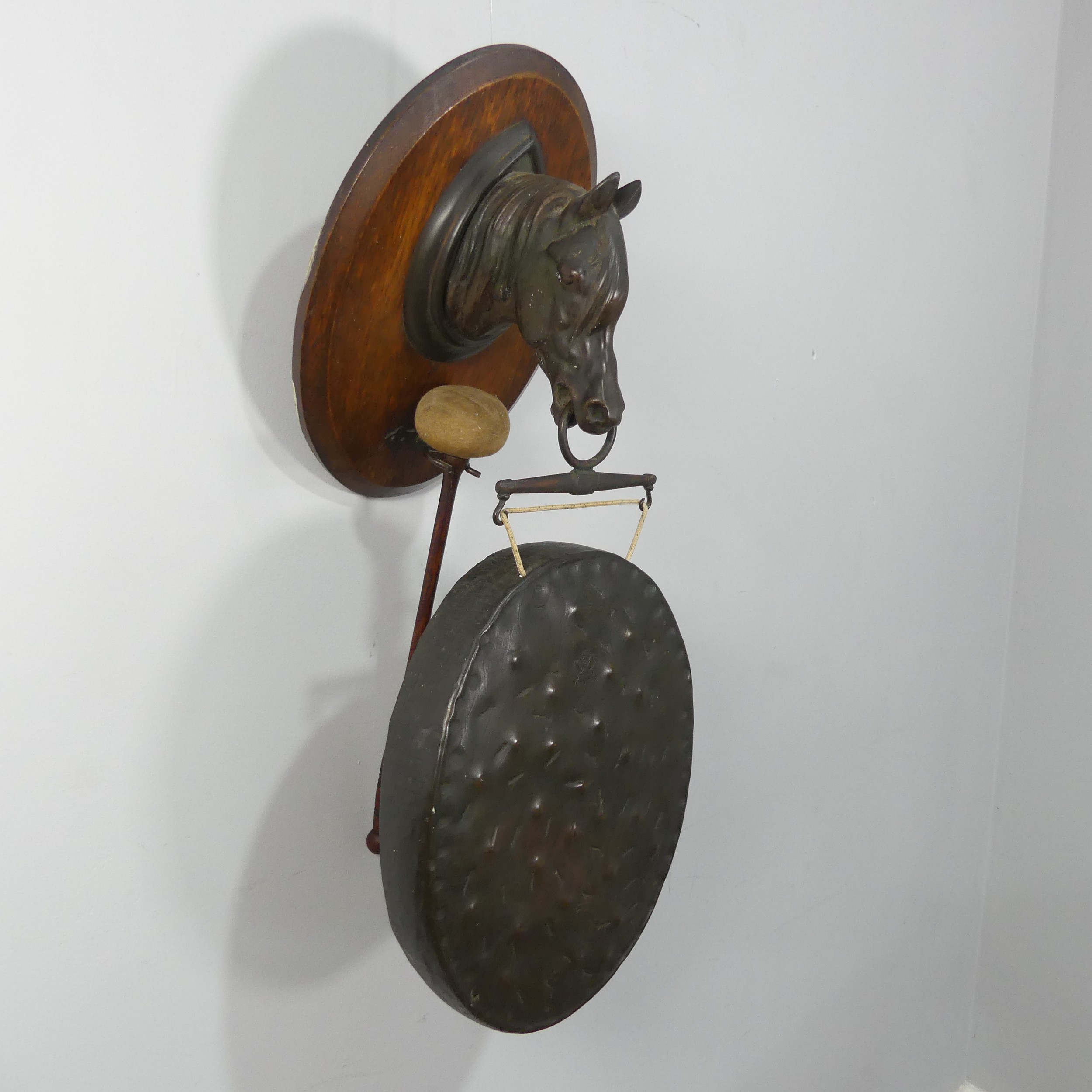 An early 20th century dinner Gong in the form of a Horse, marked 'Burmese'.