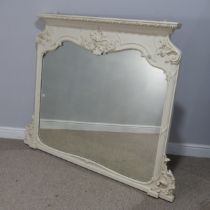 A large antique style painted overmantle Mirror, with a moulded and carved pediment flanked by