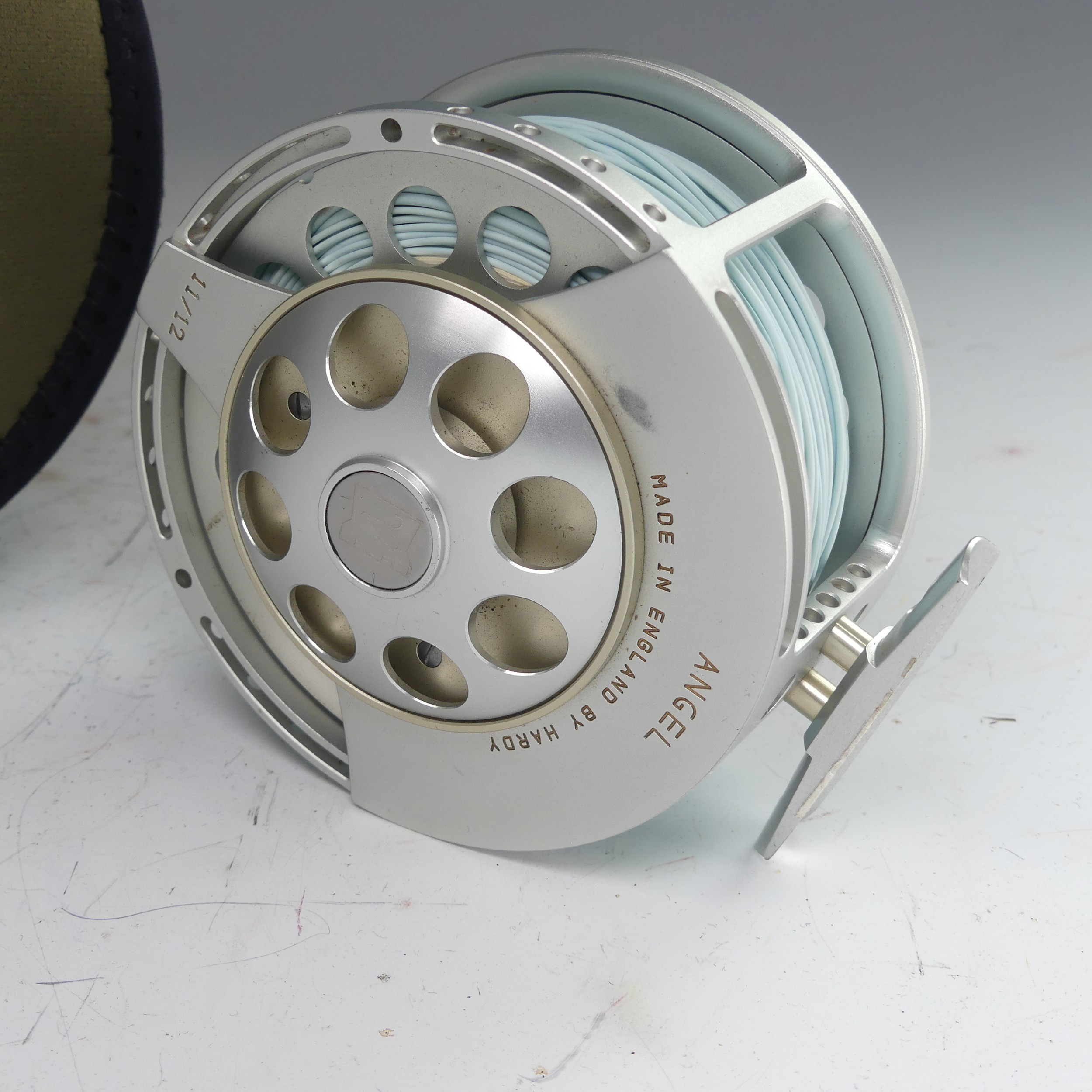 A Hardy Angel 11/12 fishing Reel, no. A26697, with Hardy pouch, 11.5cm diameter. - Image 6 of 8