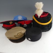 A collection of mainly reproduction British and other military Caps and Hats, including ; peaked
