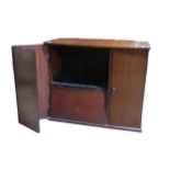 An antique mahogany storage Cabinet, hinged top over three doors concealing varying compartments,