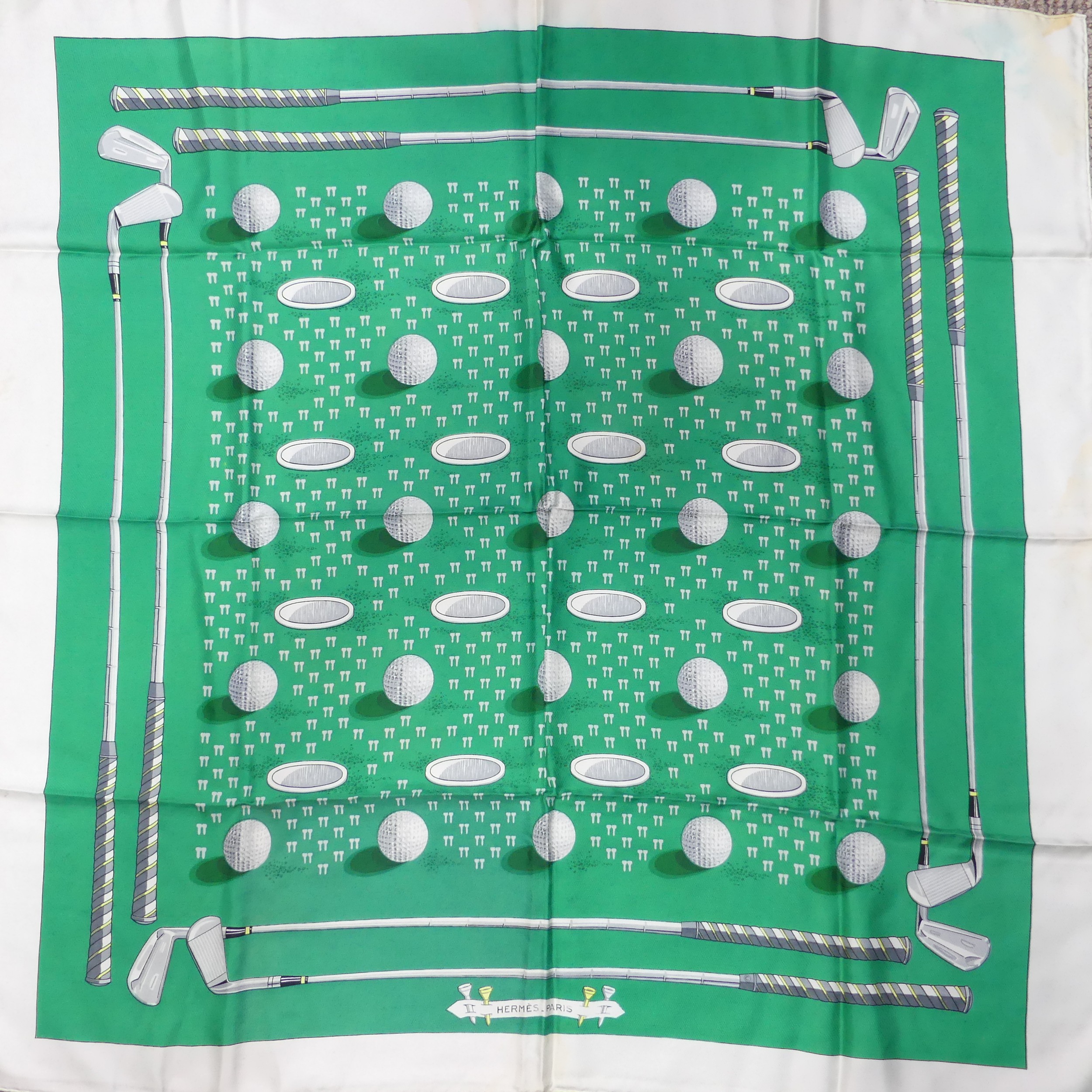 A Hermès silk twill scarf: Golf Design, green ground, hand rolled edges, with fabric composition and - Image 2 of 2