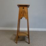 An Arts and Crafts oak plant Stand with pierced apron, raised on tapering supports, W 32 cm x H 91