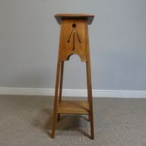 An Arts and Crafts oak plant Stand with pierced apron, raised on tapering supports, W 32 cm x H 91