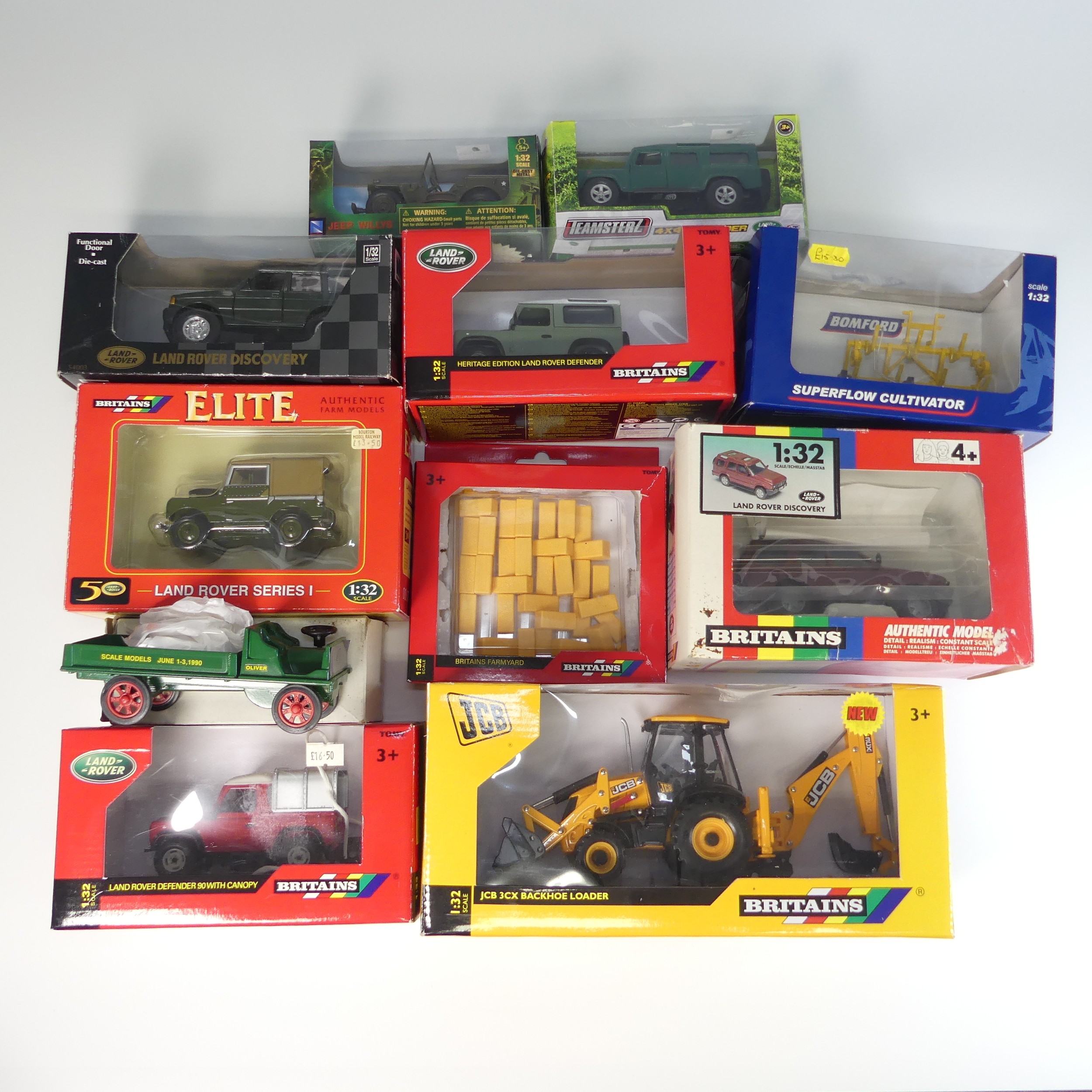 A collection of various boxed farm vehicles, including 4 Britains 1:32 scale Land Rovers: series