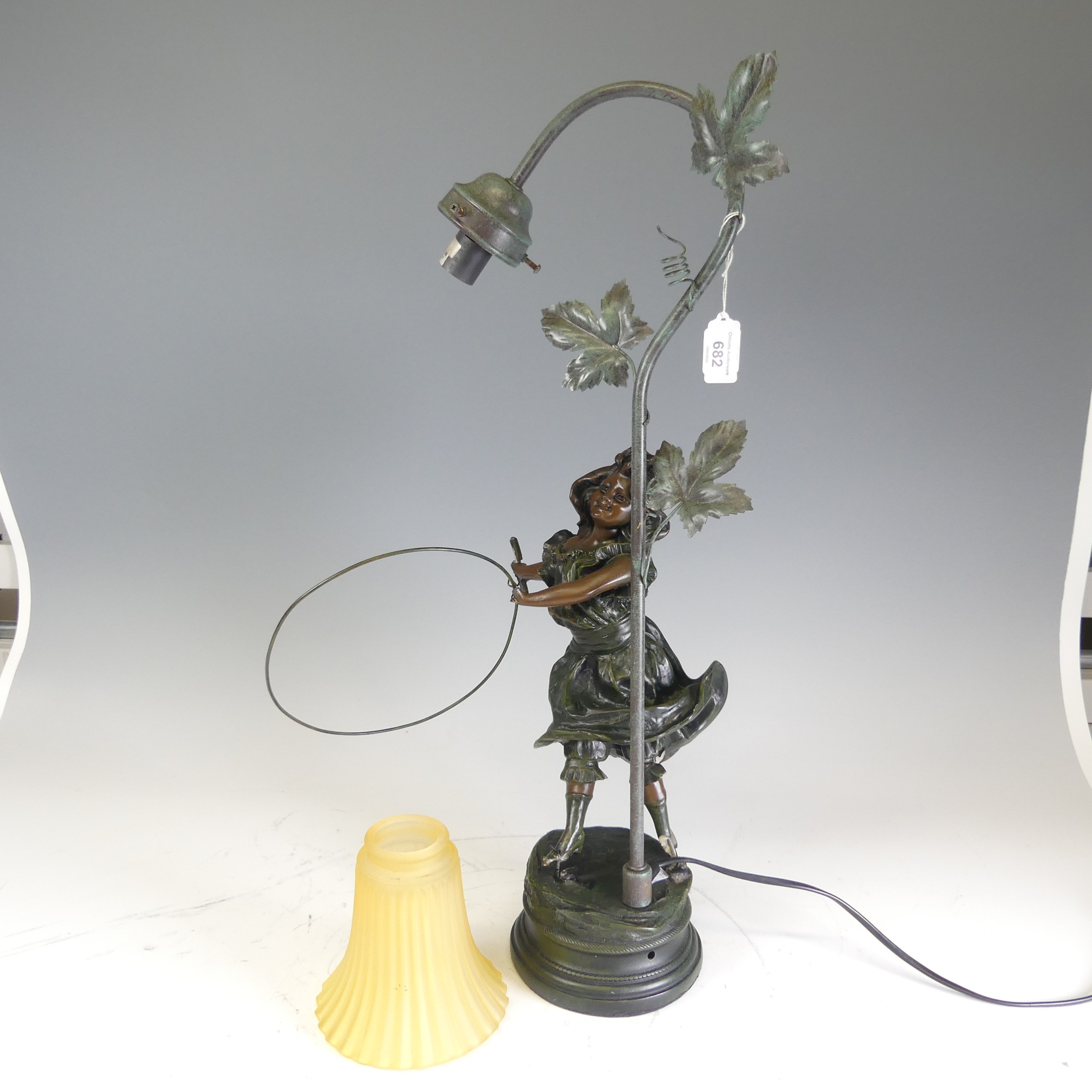 A reproduction bronzed resin Lamp, with damages see images, H 60 cm.