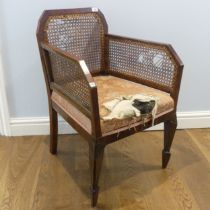 An unusual Library style Armchair, with caned backrest and armrests, above upholstered seat, note