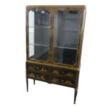 An early 20th century Chinoiserie display Cabinet, black lacquered with gilt painted decorations,