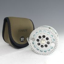 A Hardy Angel 11/12 fishing Reel, no. A26720, with Hardy pouch, 11.5cm diameter.