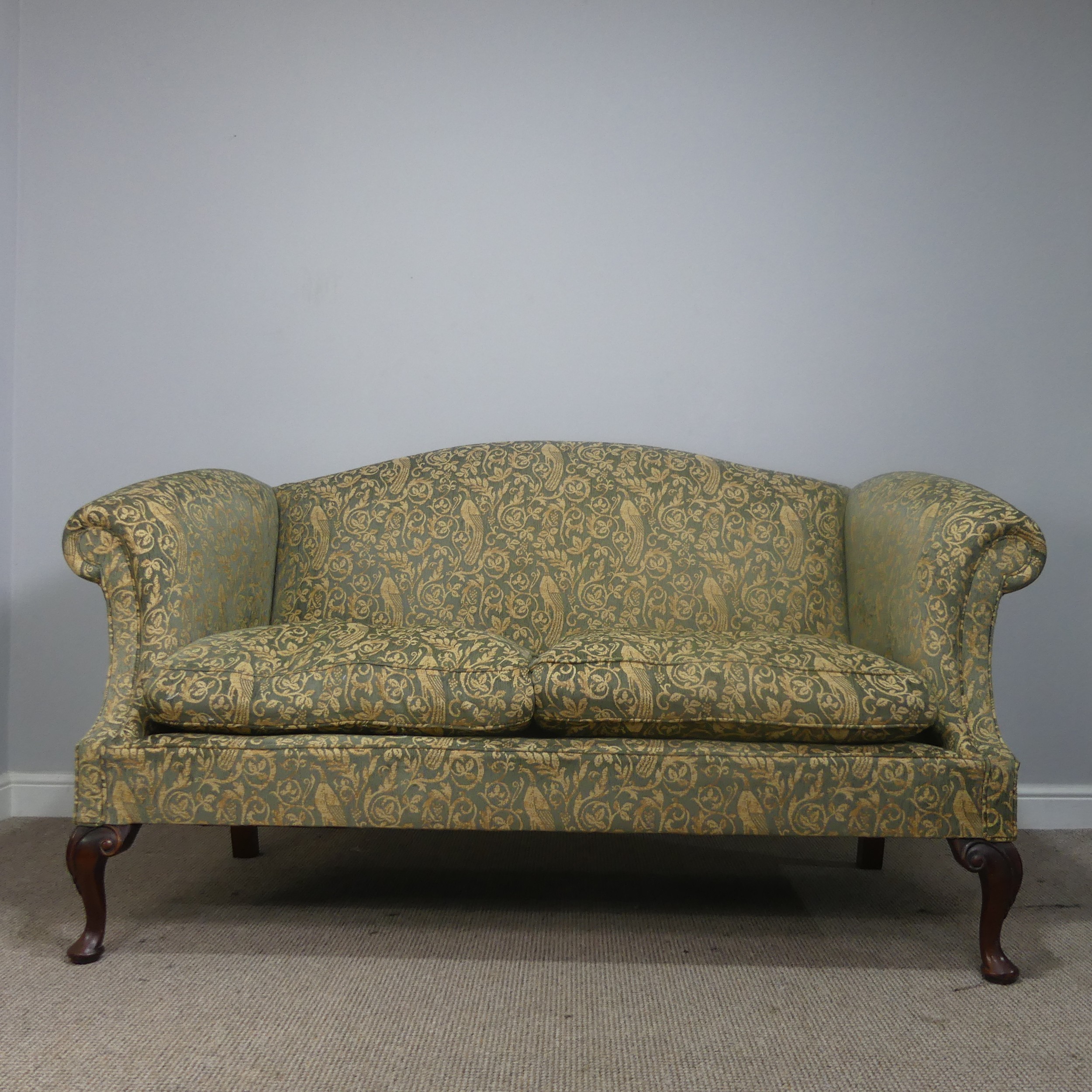 An antique George III style upholstered scroll end two-seater Sofa, raised on carved cabriole