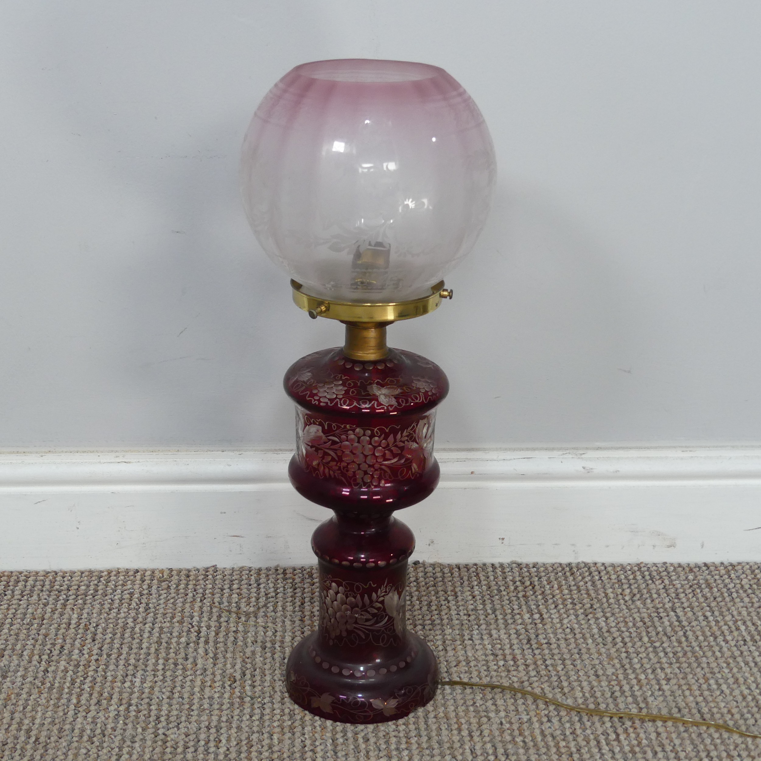 An antique ruby glass electrified Oil Lamp, with etched glass shade, H 49 cm, together with two