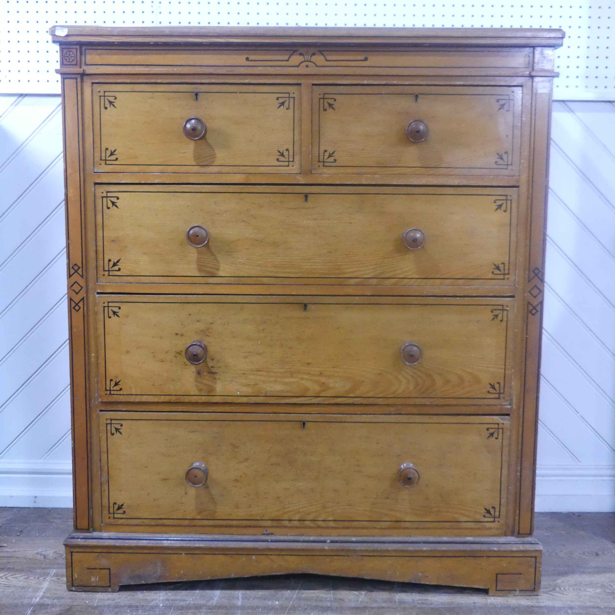 A large Aesthetic Movement pine and oak Chest of drawers, with black painted stringing and geometric