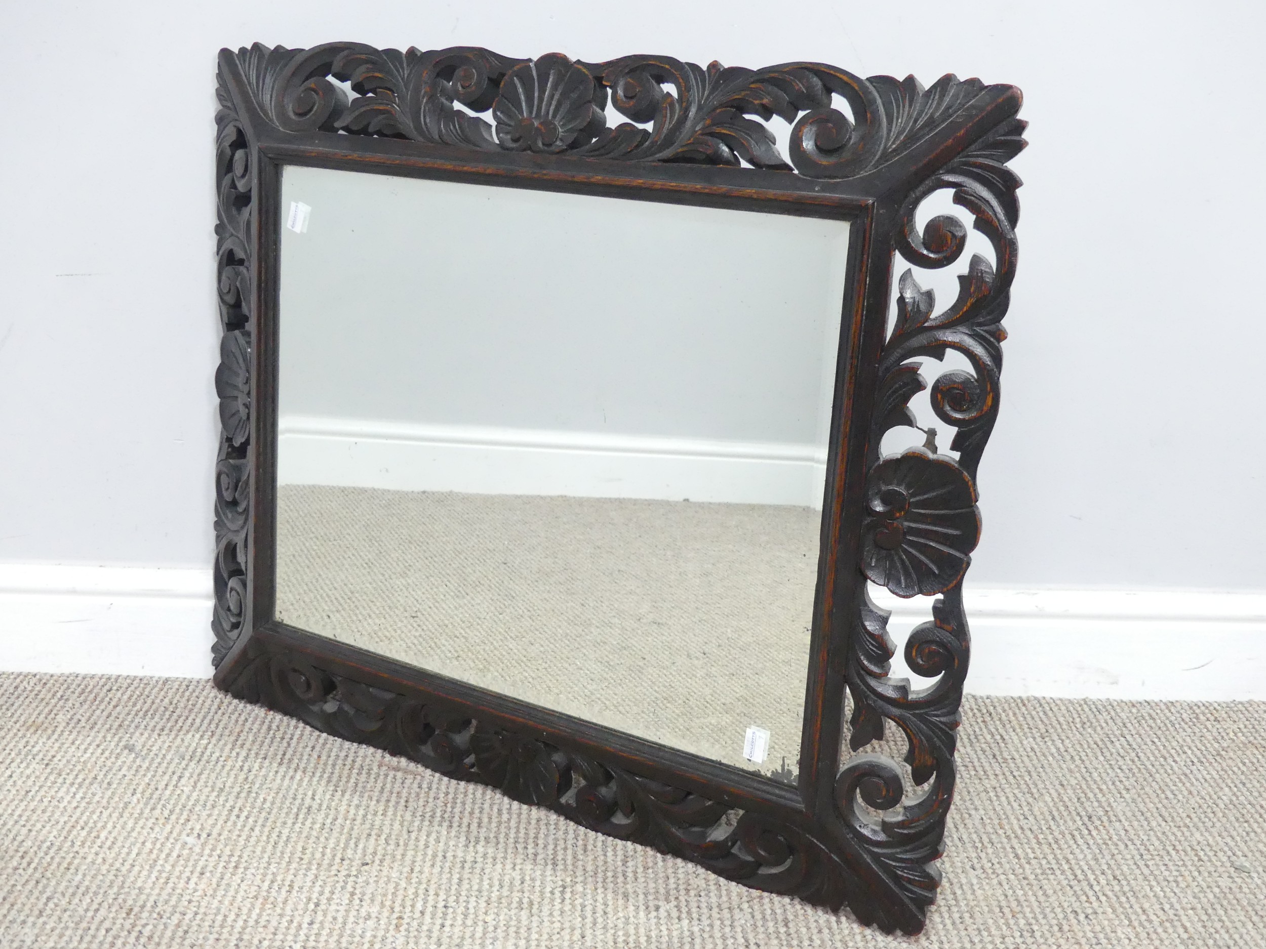 An antique carved and pierced oak rectangular wall Mirror, W 76 cm x H 62 cm.