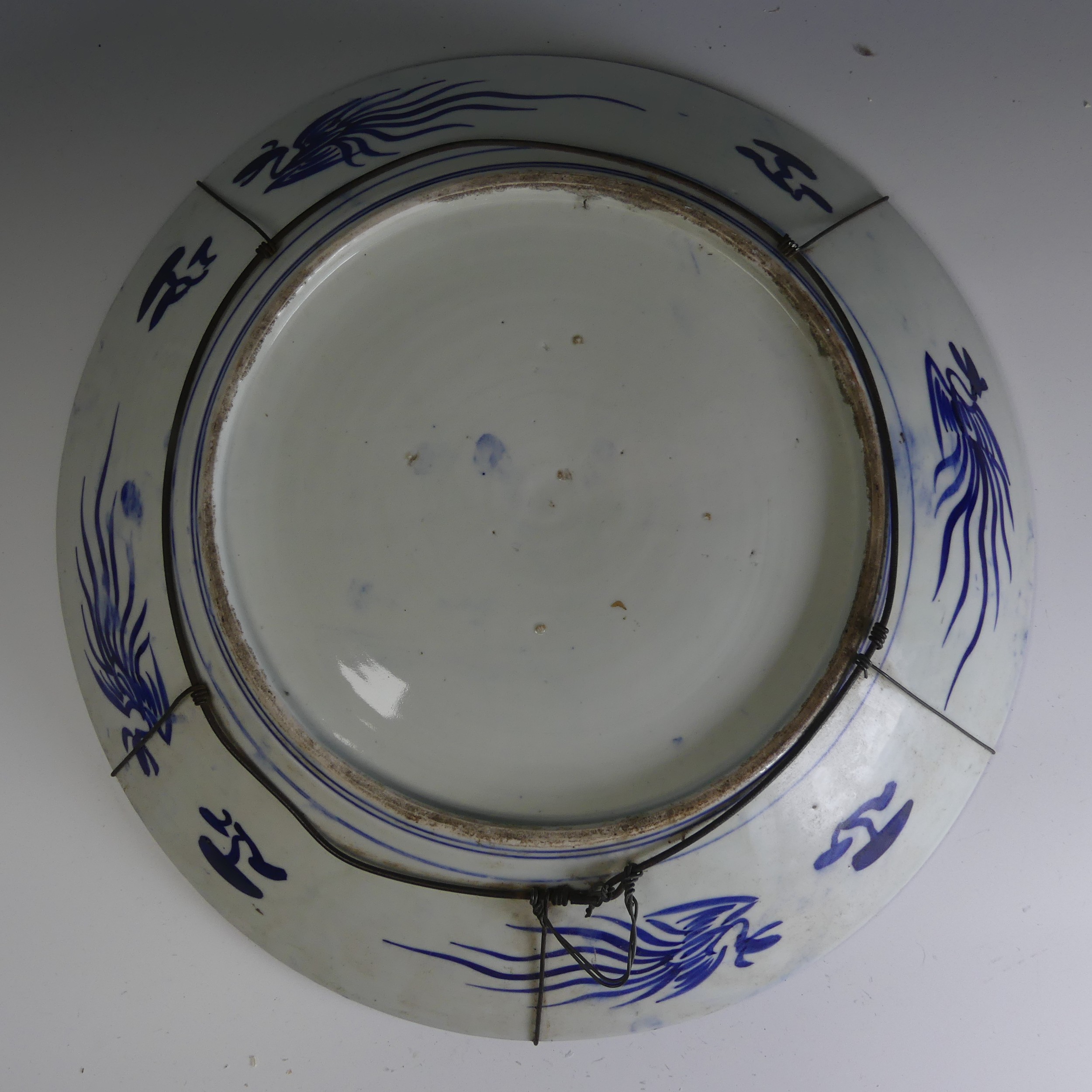 An antique Japanese Arita porcelain Charger, un underglaze blue and white depiction of mountains, - Image 2 of 2