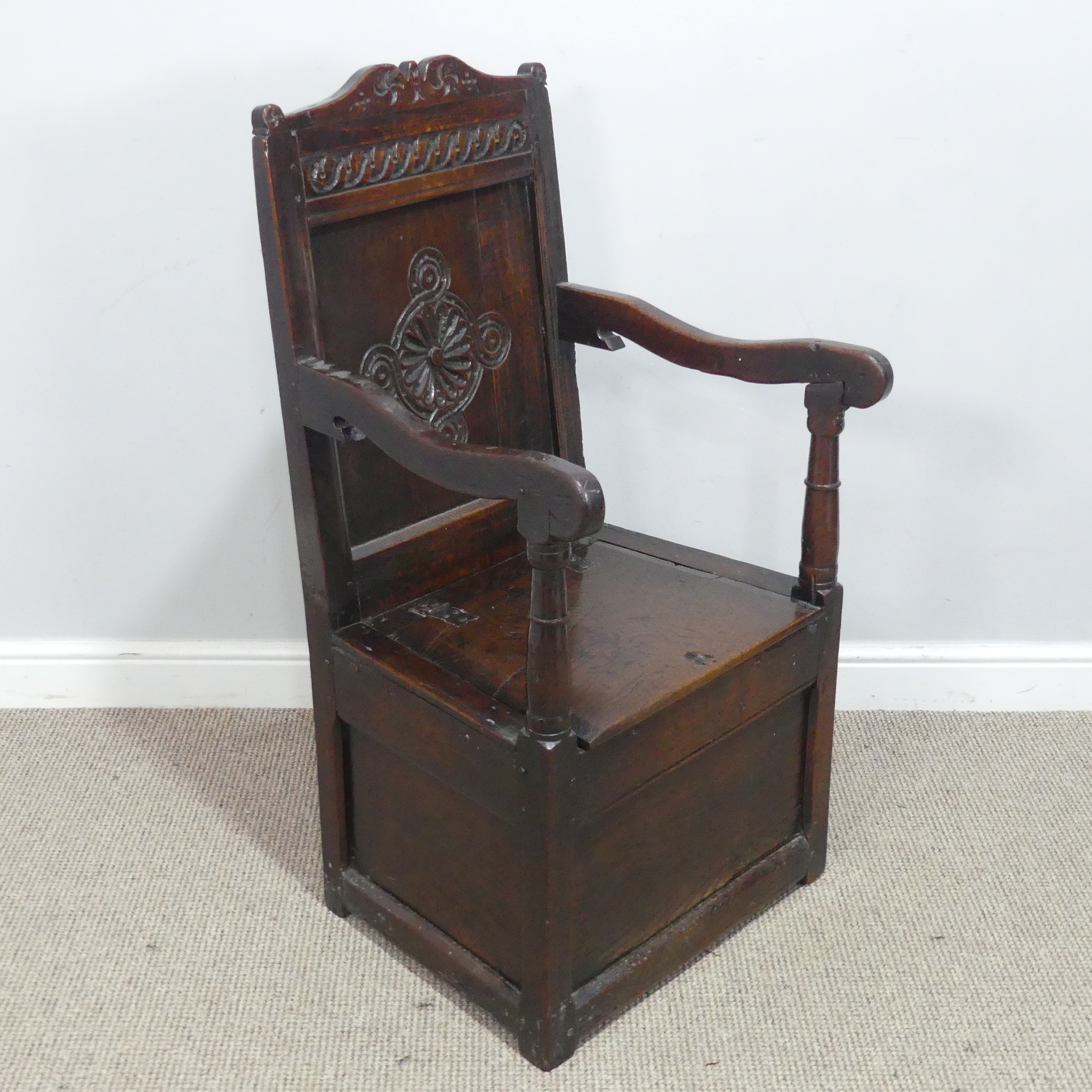 An antique probably 17th century oak wainscot box seat Armchair, carved backrest flanked by scrolled - Image 3 of 11