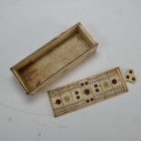 An early 19th century French Prisoner of War carved bone Games Box, the sliding cover pierced for