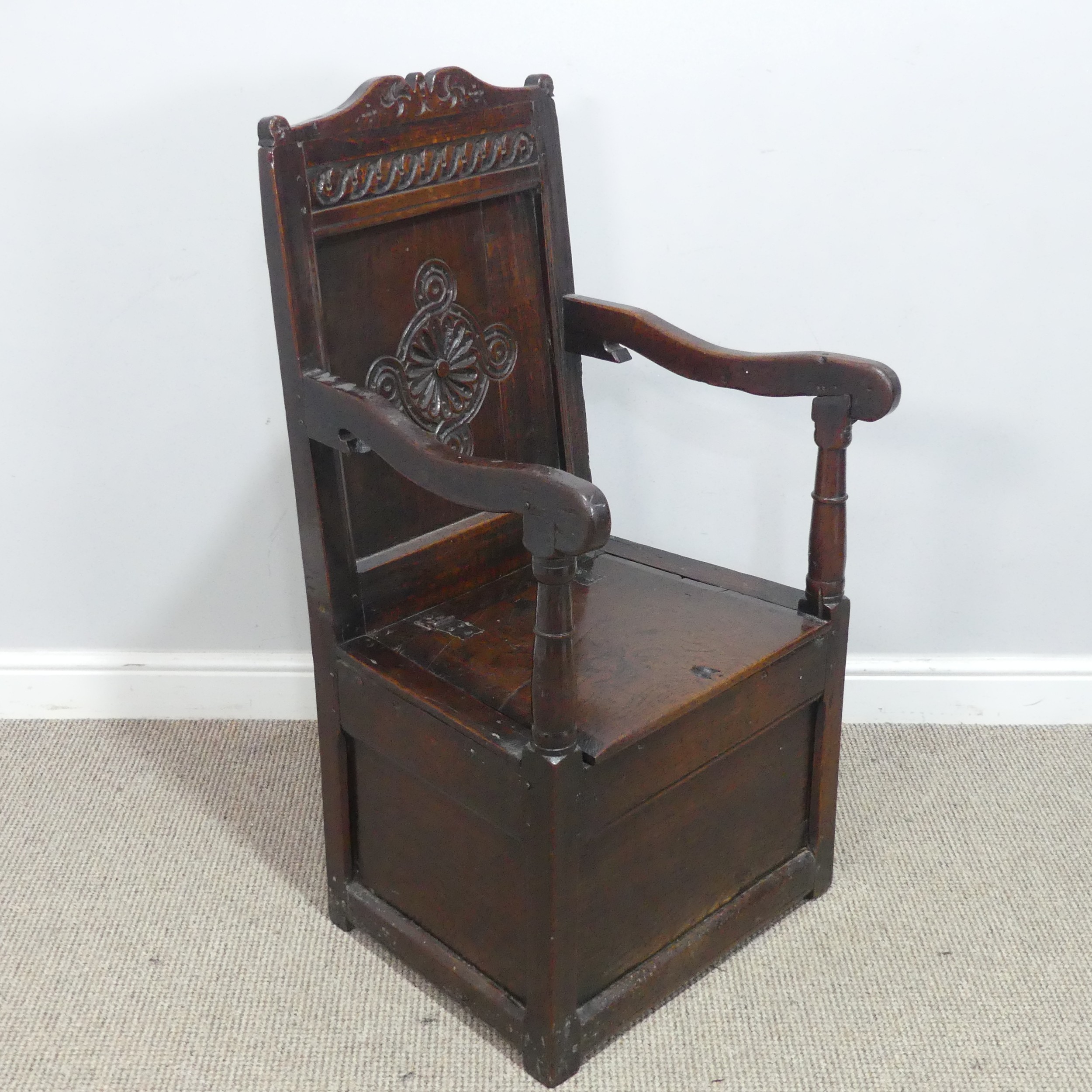 An antique probably 17th century oak wainscot box seat Armchair, carved backrest flanked by scrolled - Image 2 of 11