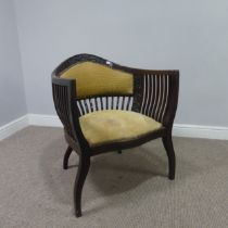 An Edwardian mahogany tub Armchair, with spindle back and arm rests, above serpentine front