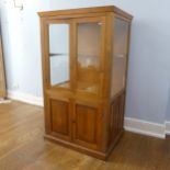 A good 20th century oak shop / museum display Cabinet, moulded top over two large glazed doors,