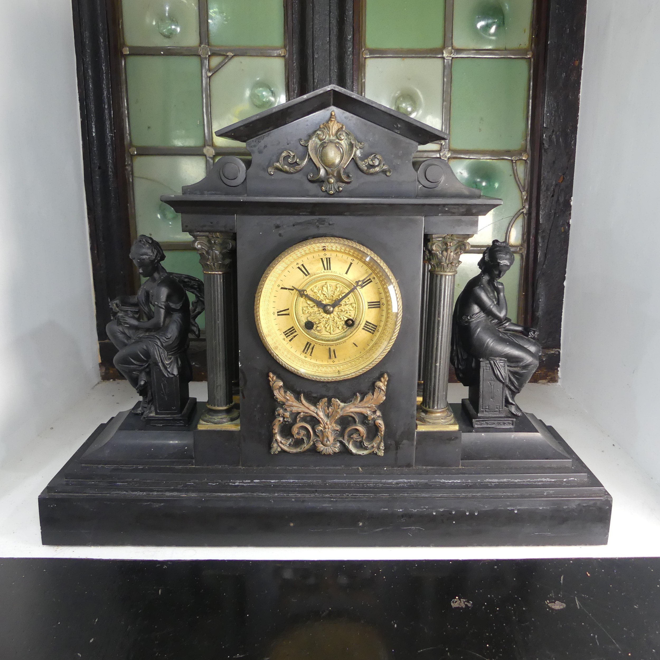 A large Victorian slate mantle Clock by Howell & James Ltd, with metal garnitures to either side,