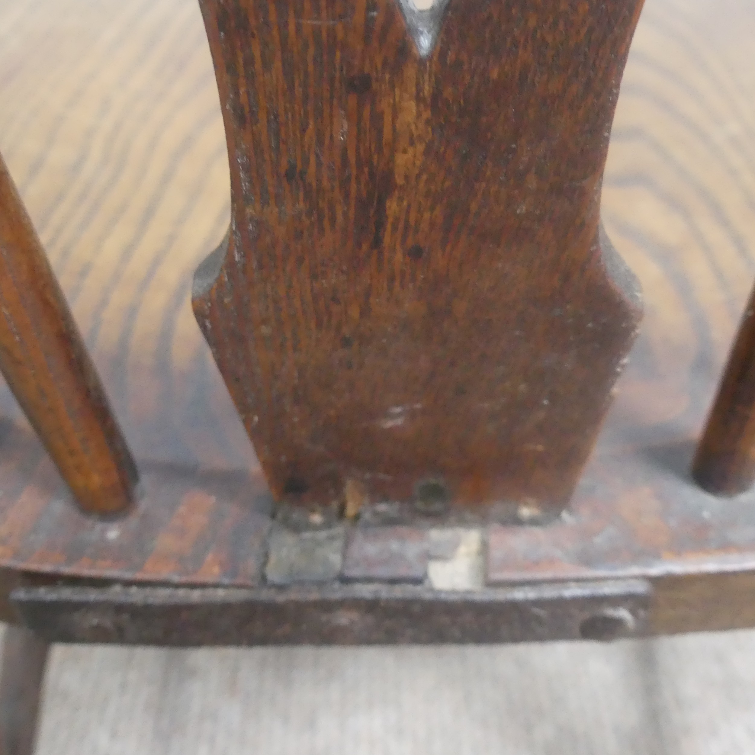 An antique ash and elm windsor Armchair, legs cuts down and with old metal repairs, W 57 cm x H 85 - Image 6 of 8