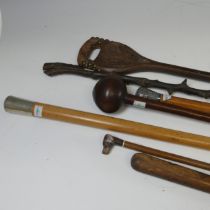 An antique novelty swagger Stick, depicting a spaniel with glass eyes, together with other walking