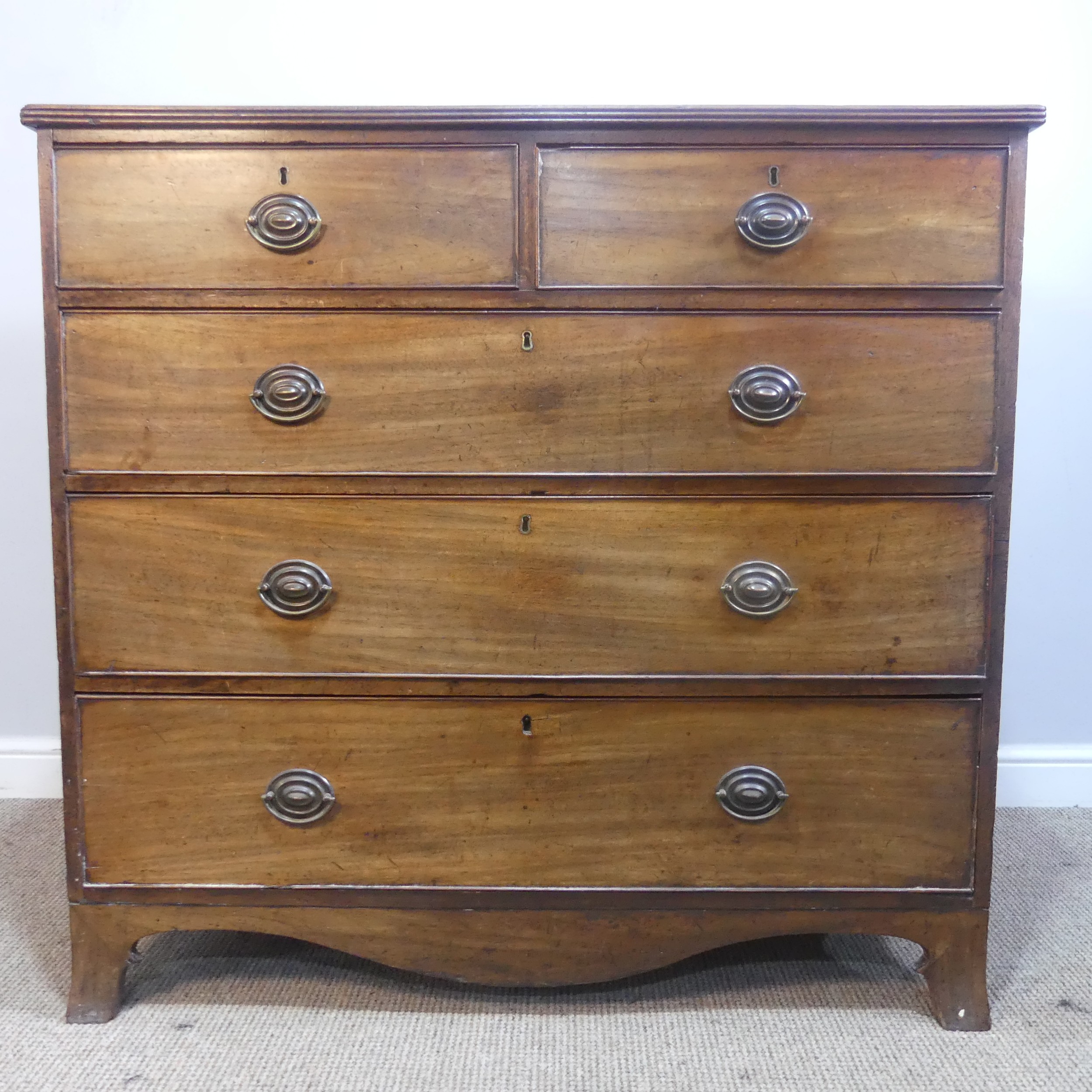 An Edwardian mahogany Chest of drawers, two short drawers over three long graduating drawers, raised