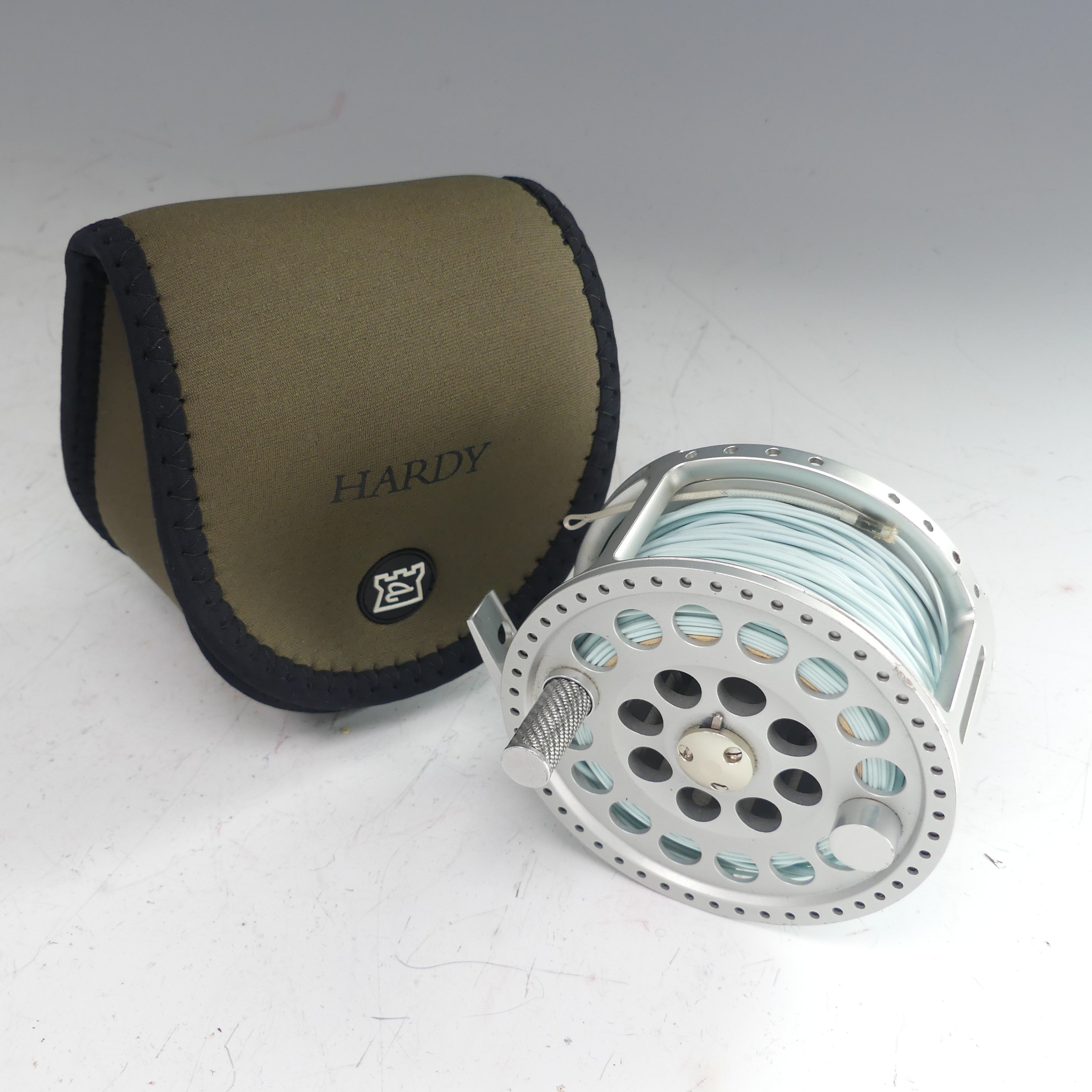 A Hardy Angel 11/12 fishing Reel, no. A26720, with Hardy pouch, 11.5cm diameter. - Image 2 of 5