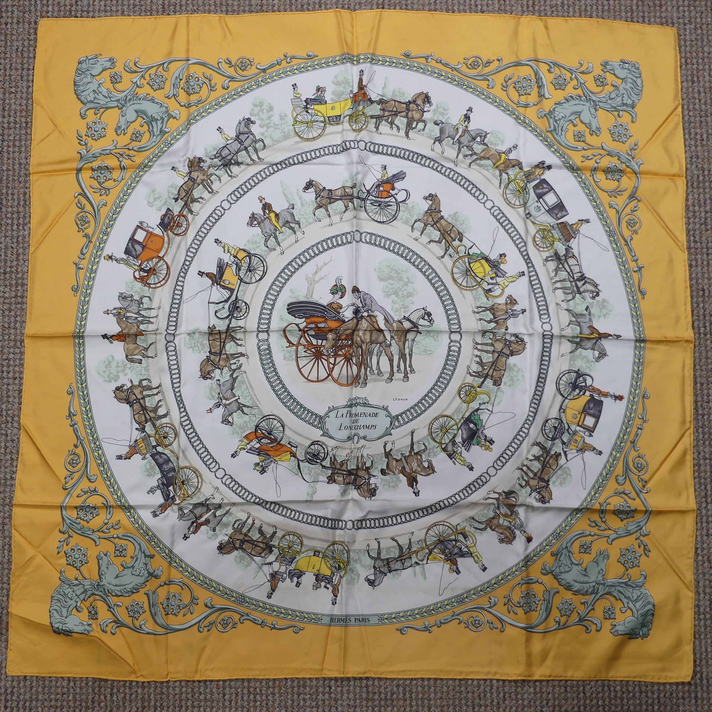 A Hermès silk twill scarf: 'La Promenade De Longchamps', designed by Philippe Ledoux, on cream