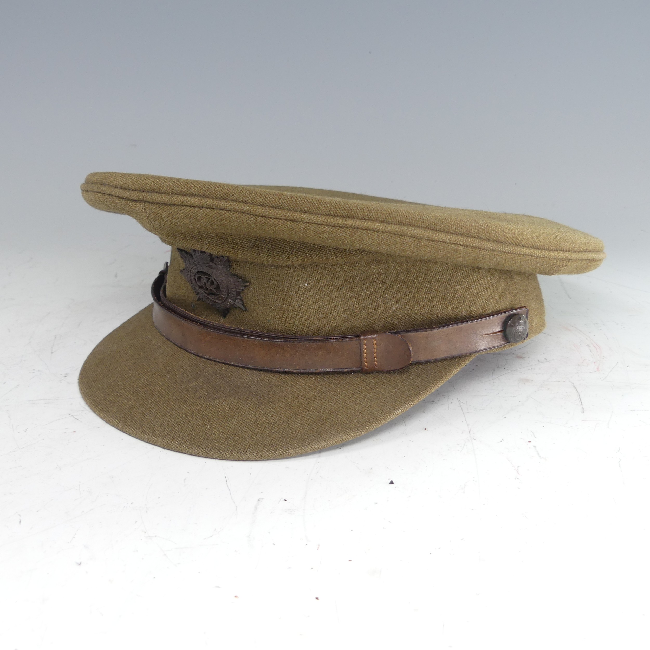 A WW2 painted tin Helmet, repainted, together with Royal Army Service Corps khaki Cap by 'W.